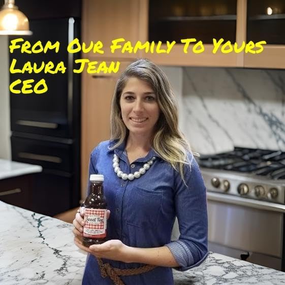CEO Laura Jean holding a bottle of Southern Sweet Tea Lemon Iced Tea in a kitchen with text From Our Family To Yours.